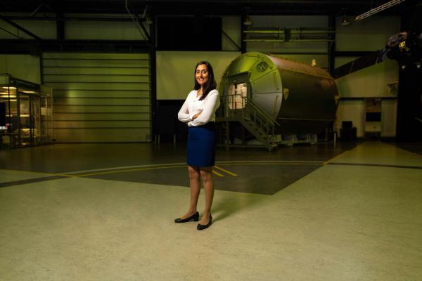 An alum stands in a hangar